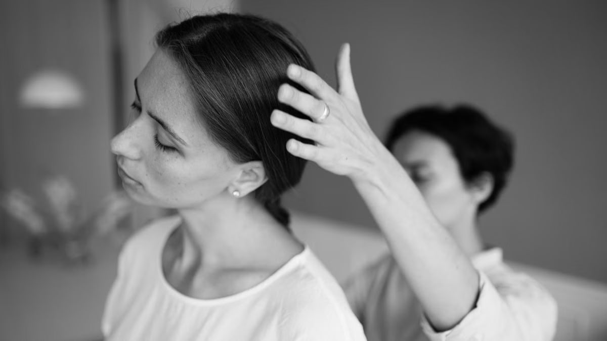 A serene black and white portrait capturing a therapy session indoors.